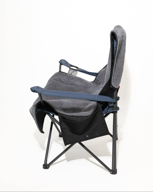 A folding camp chair with a grey fabric seat cover shown from a side angle on a white background.
